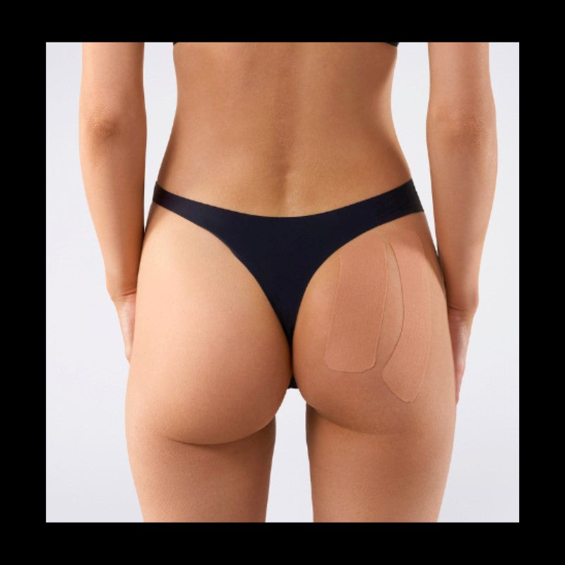 Her ses at tapen, løfter numsen nedefra og op. Ideelt hvis man ikke ønsker at have stramtsiddende bukser på.