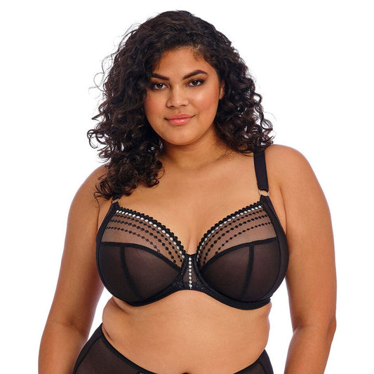 Den sorte, transparente Elomi-bh med dyb udskæring, dekorative prikker, mesh-paneler og brede, justerbare stropper for komfort.