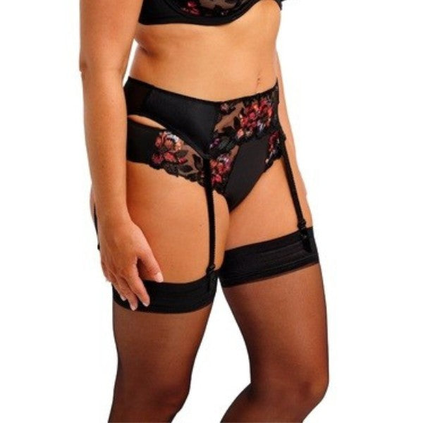 En kvinde viser sort Fantasie-lingeri med rosa blomsterbroderi, herunder en Magdalena Noir-bh, trusser, hofteholder og lårhøje strømper. Billedet er beskåret til hendes overkrop, hofter og lår på en almindelig hvid baggrund.