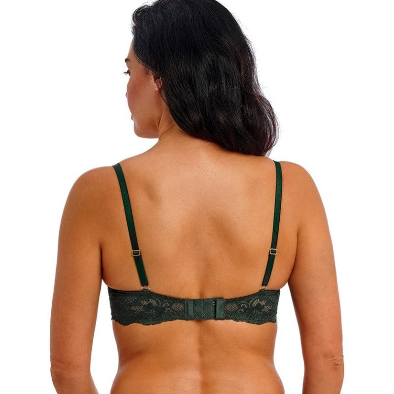 En kvinde med langt mørkt hår ses bagfra iført en skovgrøn blond fuldskåls-BH fra Wacoal med justerbare stropper og hægtelukning, som fremhæver hendes skuldre og øverste del af ryggen mod en almindelig hvid baggrund.